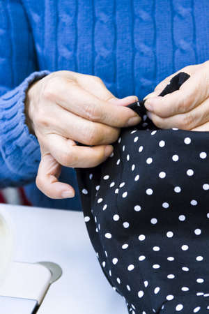 Hands work a sewing machine.の写真素材