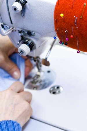 Hands work a sewing machine.の写真素材