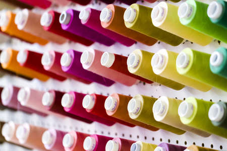 Colorful spools of thread on the wall in tailor shop.のeditorial素材