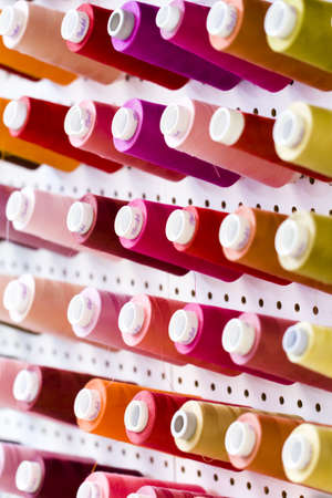 Colorful spools of thread on the wall in tailor shop.のeditorial素材