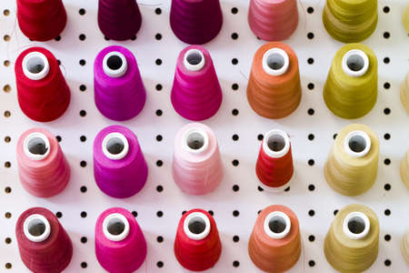 Colorful spools of thread on the wall in tailor shop.のeditorial素材