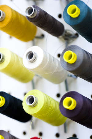 Colorful spools of thread on the wall in tailor shop.のeditorial素材