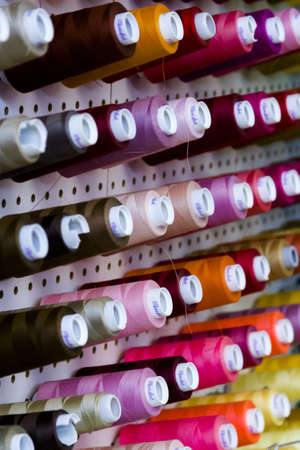 Colorful spools of thread on the wall in tailor shop.のeditorial素材
