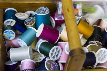 Colorful spools of thread on the wall in tailor shop.のeditorial素材