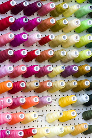 Colorful spools of thread on the wall in tailor shop.のeditorial素材