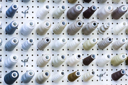Colorful spools of thread on the wall in tailor shop.のeditorial素材