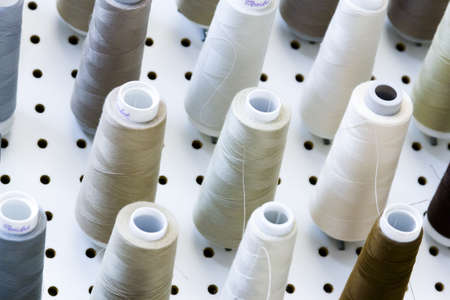 Colorful spools of thread on the wall in tailor shop.のeditorial素材