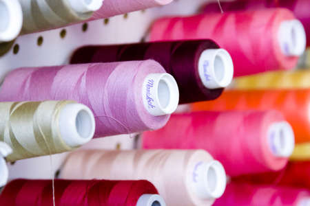 Colorful spools of thread on the wall in tailor shop.のeditorial素材