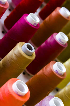 Colorful spools of thread on the wall in tailor shop.のeditorial素材
