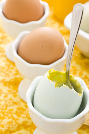 Soft boiled egg in egg cup and served with toast fingers.