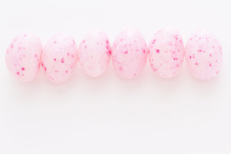 Assorted jelly beans in pastel colors with darker spots.
