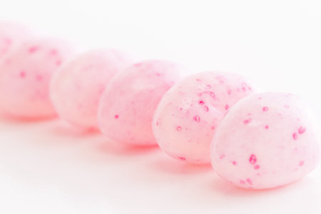 Assorted jelly beans in pastel colors with darker spots.