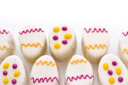 Easter egg petit cakes made with layers of vanilla cake and tart, raspberry jam.