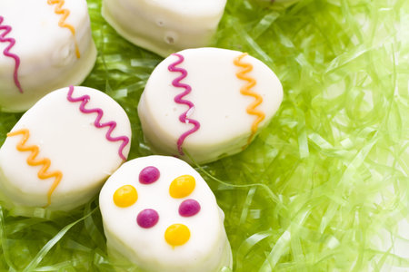 Easter egg petit cakes made with layers of vanilla cake and tart, raspberry jam.