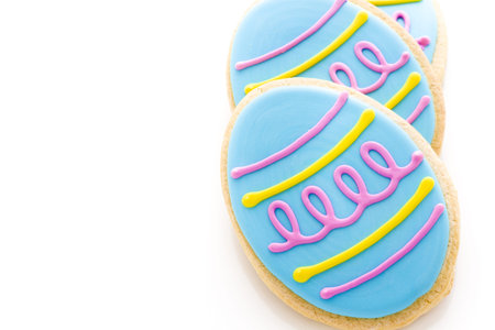 Easter cookies in shape of egg decorated with blue icing.