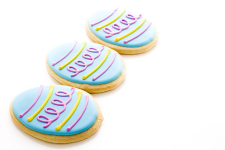 Easter cookies in shape of egg decorated with blue icing.