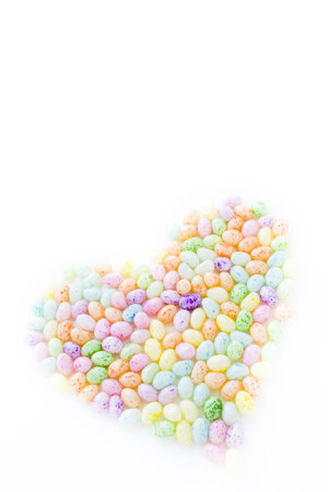 Assorted jelly beans in pastel colors with darker spots.