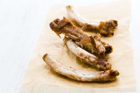 Rib bones picked clean of meat on parchment paper の写真素材