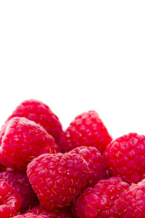 Heap of organic raspberries on white background.