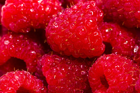 Heap of organic raspberries on white background.