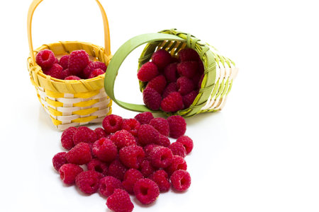 Heap of organic raspberries on white background.
