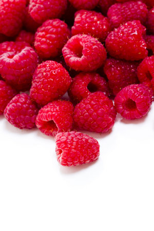 Heap of organic raspberries on white background.