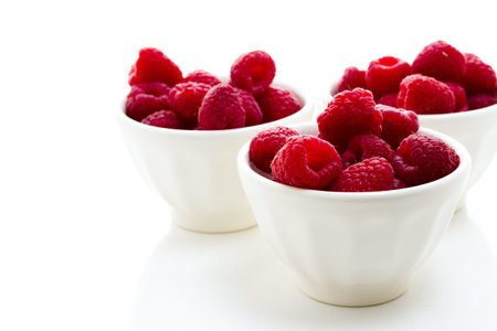 Heap of organic raspberries on white background.の写真素材