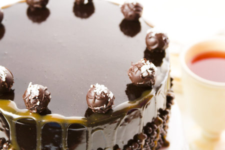 Salted caramel truffle torte with layers of chocolate cake filled with salted caramel mousse,...