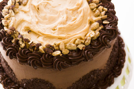 Peanut butter mousse cake with two layers of chocolate cake, filled and topped with peanut butter...
