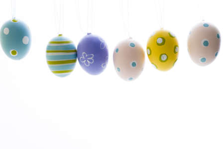 Hand painted Easter eggs hanging on ribbons.の写真素材