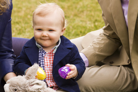A young family with baby boy in the park on a nice Spring day.の写真素材