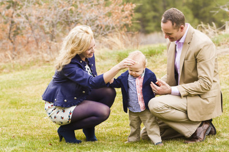 A young family with baby boy in the park on a nice Spring day.