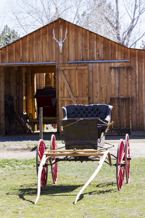 Old carriage with red wheels on display.の写真素材