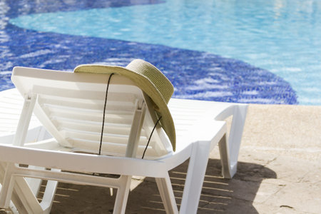 White plastic pool chairs at the swimming pool.