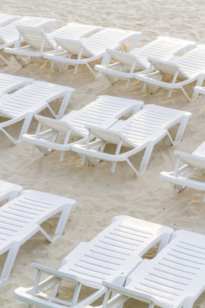 White pool chairs on the beach.の写真素材