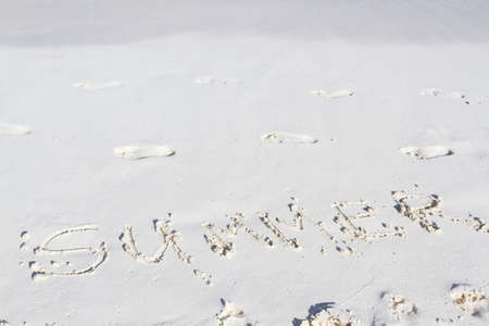 Summer written on the beach with wave.の写真素材