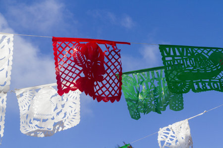 Traditional papel picado decorating a garden.の写真素材