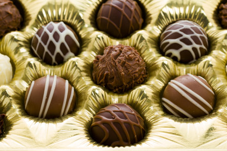 Box of assorted gourmet truffles on a white background.