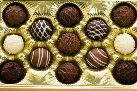 Box of assorted gourmet truffles on a white background.の写真素材