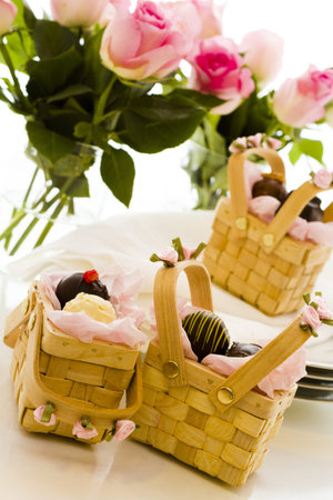 Miniature picnic baskets favor boxes filled with truffles.の写真素材