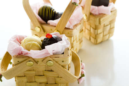 Miniature picnic baskets favor boxes filled with truffles.の写真素材