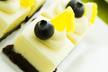 Small white chocolate cheesecake squares at dessert bar.の写真素材