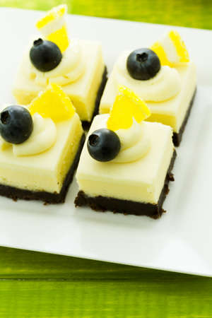 Small white chocolate cheesecake squares at dessert bar.の写真素材