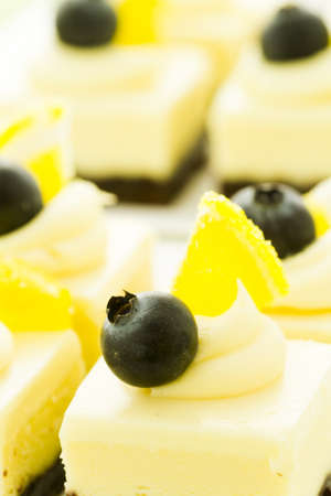 Small white chocolate cheesecake squares at dessert bar.の写真素材