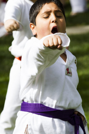 Tae Kwon Do student practicing in the park.