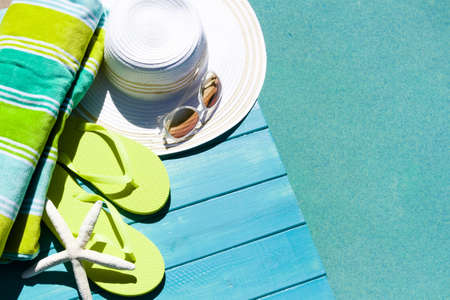 Colorful flip flops by a swimming pool.の写真素材