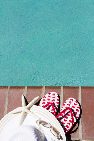 Colorful flip flops by a swimming pool.の写真素材