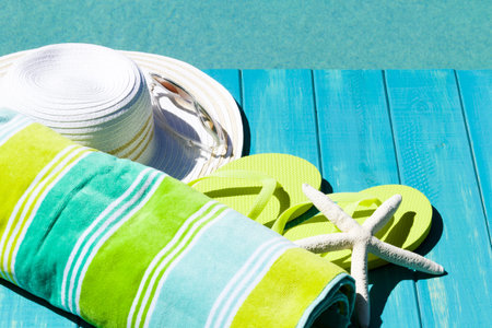 Colorful flip flops by a swimming pool.の写真素材