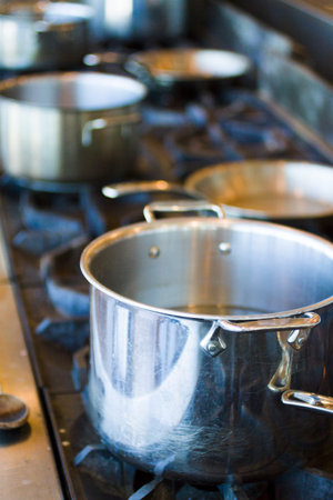 Cooking pots and pans on a gas stove.の写真素材
