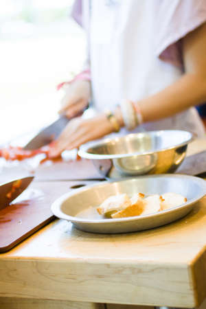 Kinds in cooking class making bruschetta.の写真素材